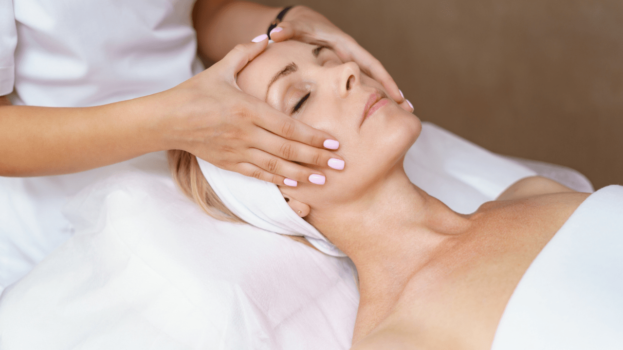 A woman enjoying a relaxing facial massage at a spa.