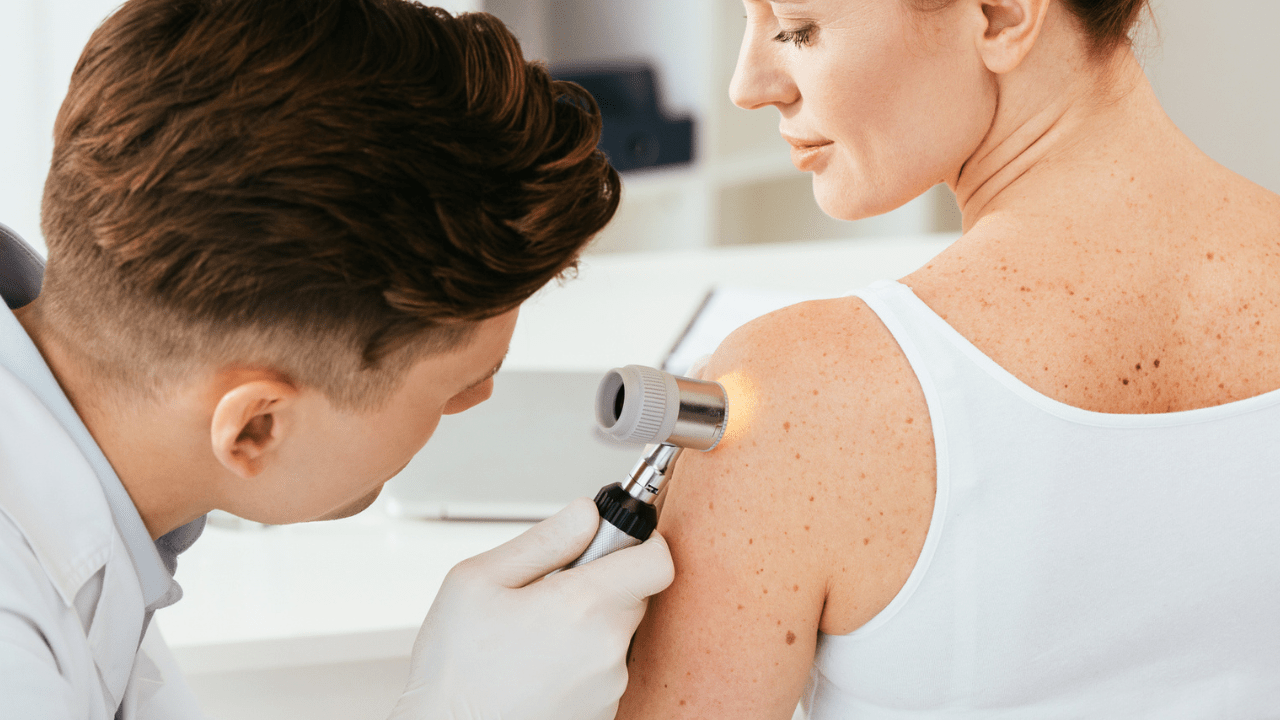 Woman getting her skin checked out by a dermatologist