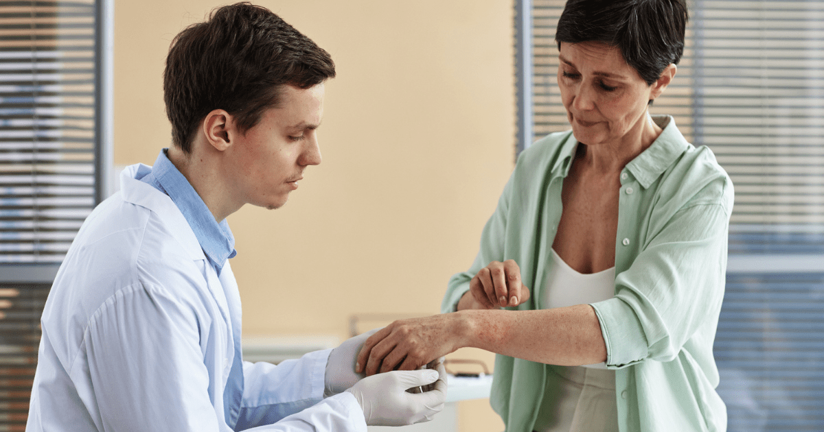 woman getting her skin checked by a male dermatologist